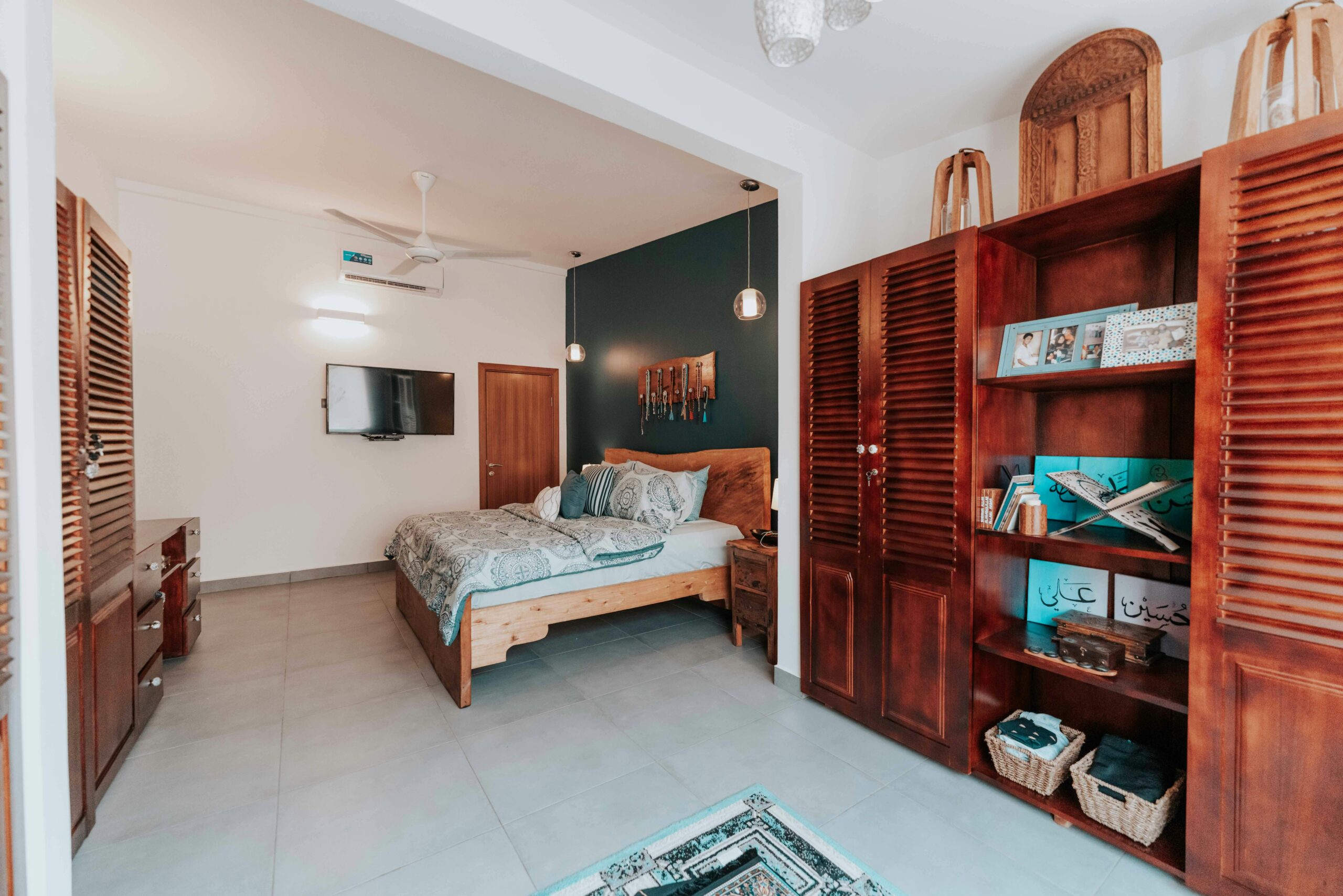 Stylish bedroom featuring wooden furniture, a cozy bed, and minimalistic decor.